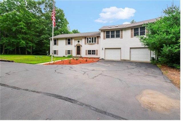 split foyer home with a front lawn and a garage