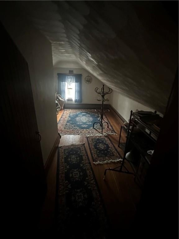 bonus room with wood-type flooring and lofted ceiling