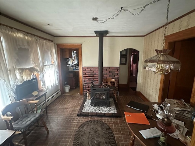 miscellaneous room with a notable chandelier, plenty of natural light, a wood stove, and ornamental molding