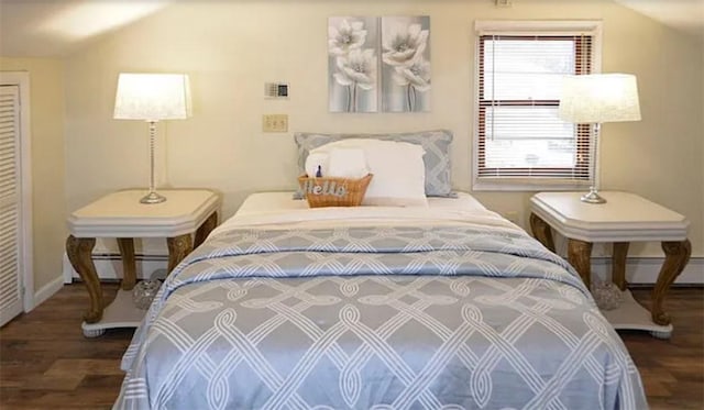 bedroom featuring dark wood-type flooring and baseboard heating