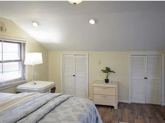 bedroom featuring dark wood-type flooring and lofted ceiling