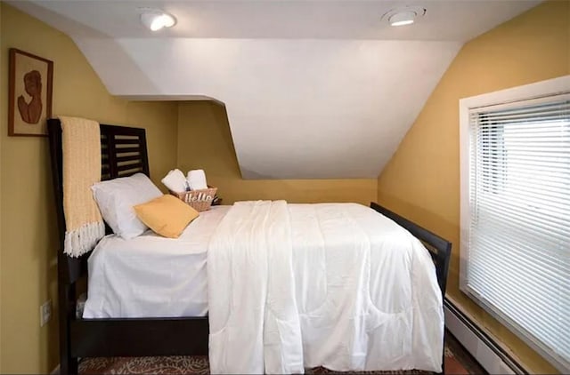 bedroom featuring baseboard heating and vaulted ceiling