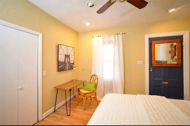 bedroom with ceiling fan, a closet, and hardwood / wood-style flooring