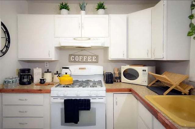 kitchen featuring sink, white appliances, and white cabinets