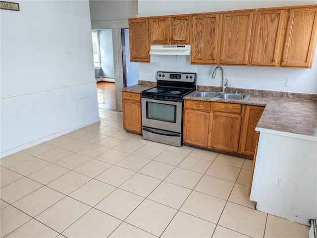 kitchen with sink, light tile patterned floors, and electric range