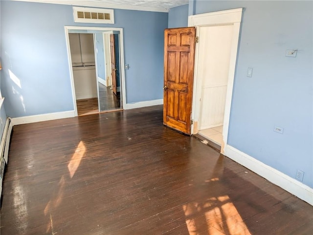 unfurnished bedroom featuring dark wood-type flooring and a closet