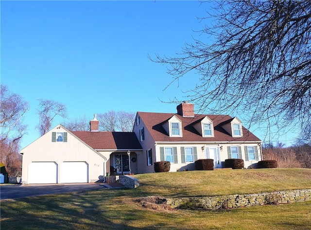 new england style home featuring a front lawn and a garage