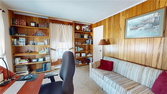 carpeted office featuring baseboard heating, wooden walls, and crown molding