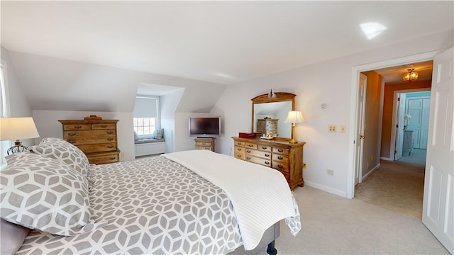 carpeted bedroom with vaulted ceiling