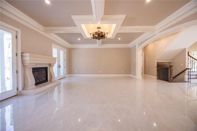 unfurnished living room with a chandelier, a fireplace, plenty of natural light, and ornamental molding