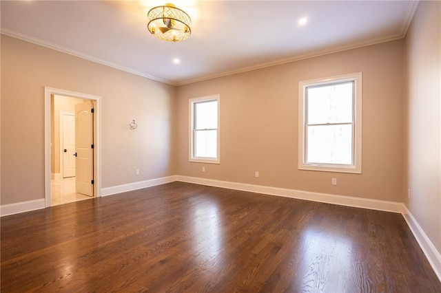 empty room with plenty of natural light, ornamental molding, and dark hardwood / wood-style floors