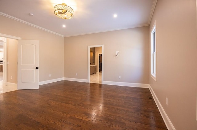 spare room with crown molding and dark hardwood / wood-style floors