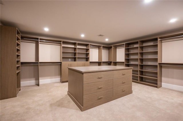 walk in closet featuring light carpet