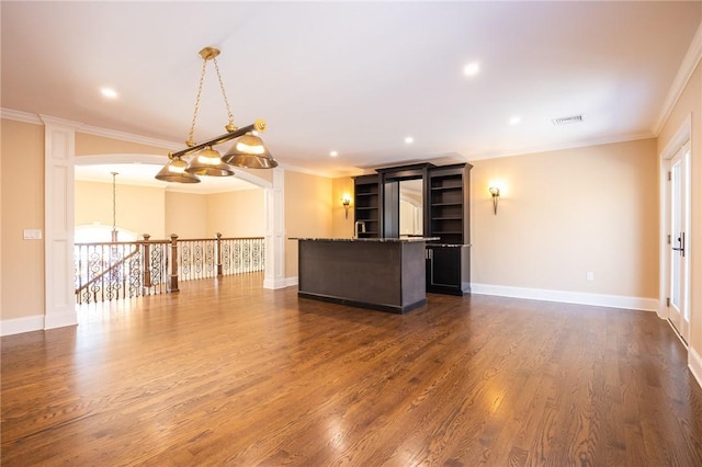 unfurnished living room featuring dark hardwood / wood-style floors and ornamental molding