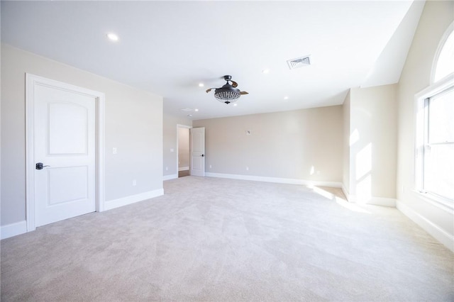 carpeted spare room featuring vaulted ceiling and ceiling fan