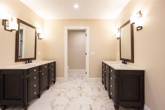 bathroom featuring toilet and vanity