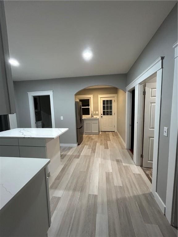 hall with light hardwood / wood-style floors