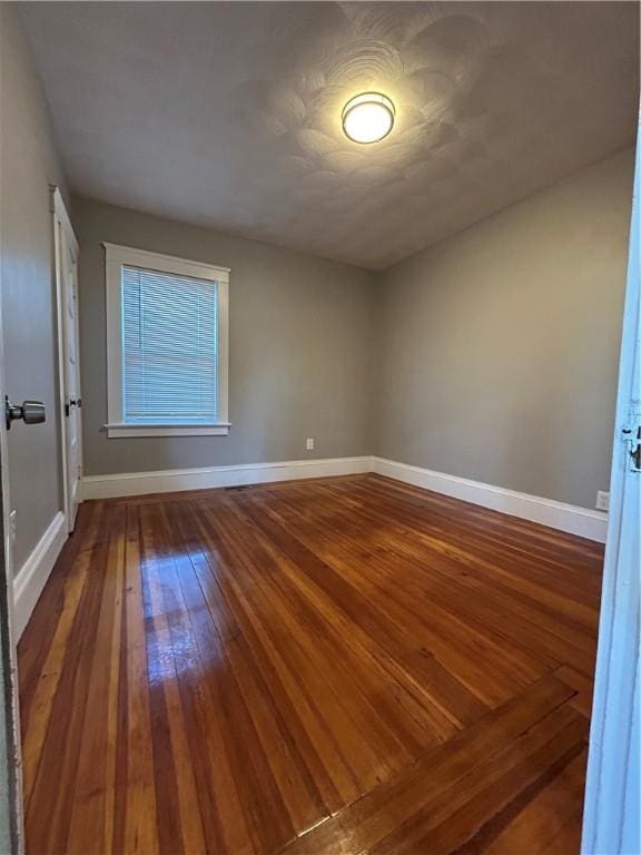 empty room with hardwood / wood-style floors