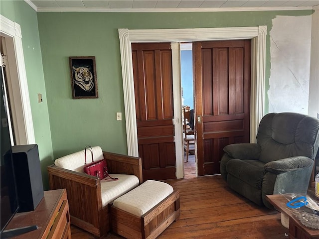 sitting room featuring crown molding and dark hardwood / wood-style floors