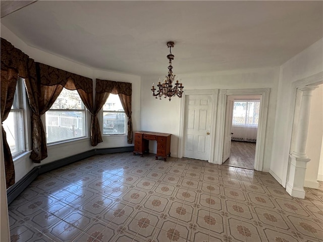 unfurnished dining area with ornate columns, a wealth of natural light, and a notable chandelier