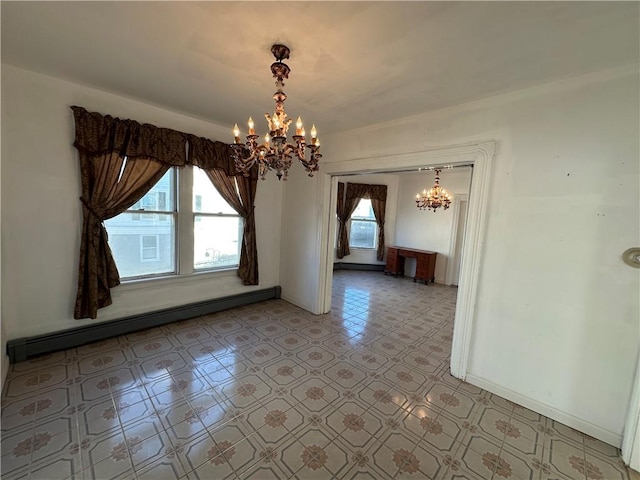 unfurnished room featuring a baseboard heating unit, plenty of natural light, and a chandelier