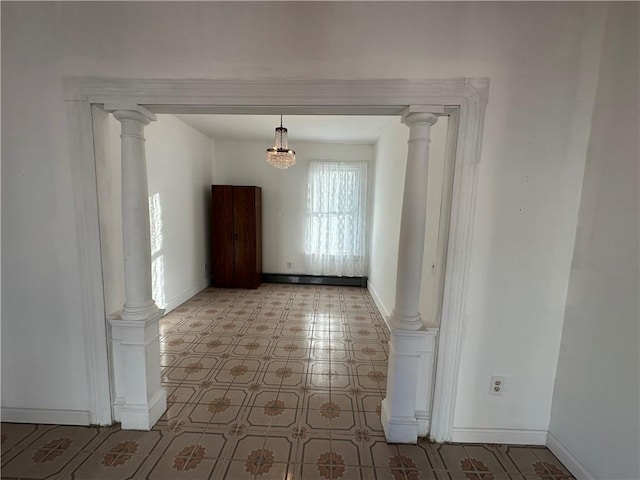 unfurnished room with ornate columns