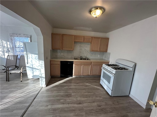 kitchen featuring white gas range, decorative backsplash, black dishwasher, and light brown cabinets