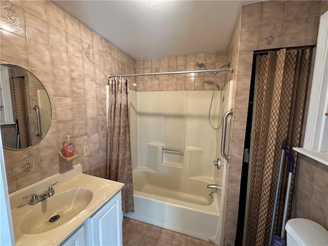 full bathroom featuring tile walls, vanity, shower / bath combination with curtain, tile patterned floors, and toilet