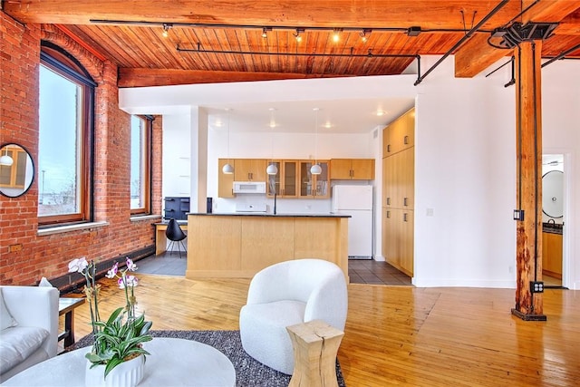 living room with light wood-type flooring, brick wall, and wooden ceiling