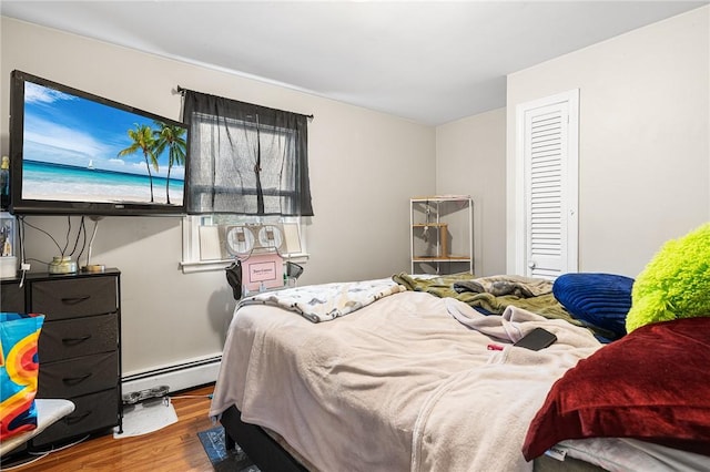 bedroom featuring hardwood / wood-style flooring and a baseboard radiator