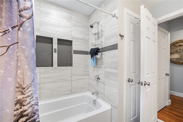 bathroom featuring hardwood / wood-style flooring and shower / tub combo