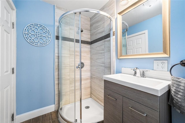 bathroom with a shower with door and vanity