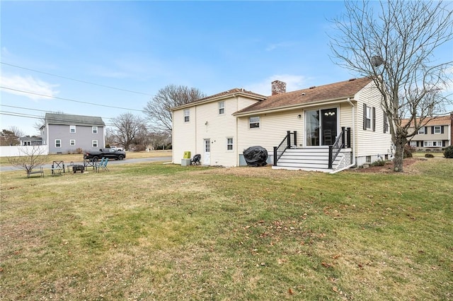 back of property featuring a lawn