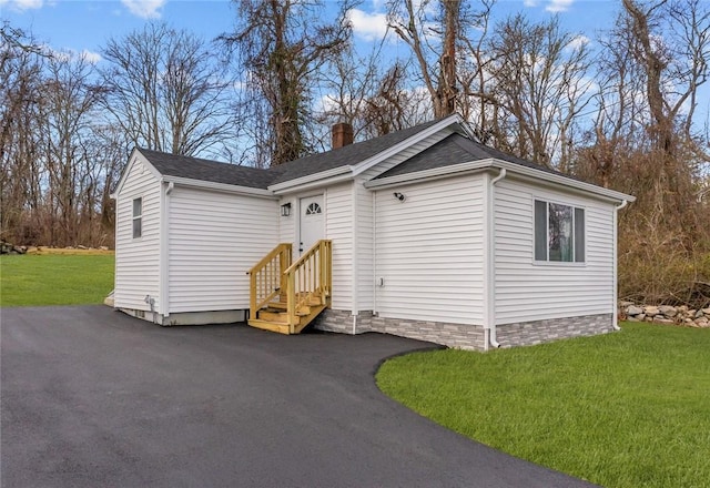 view of outbuilding featuring a yard