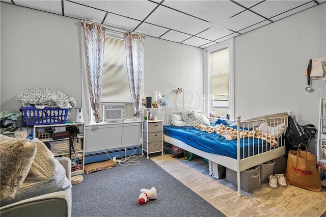 bedroom featuring multiple windows, cooling unit, carpet floors, and a baseboard radiator