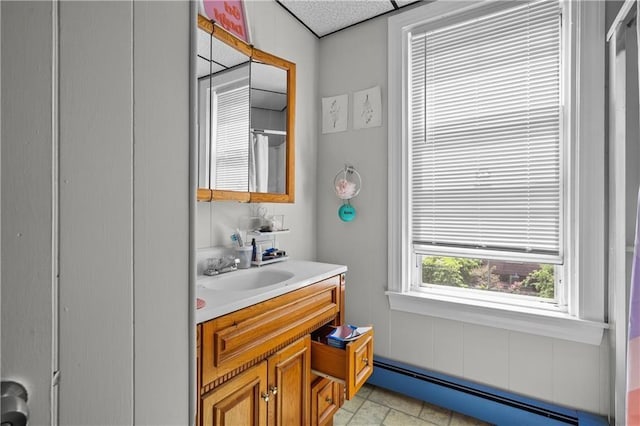 bathroom with baseboard heating and vanity