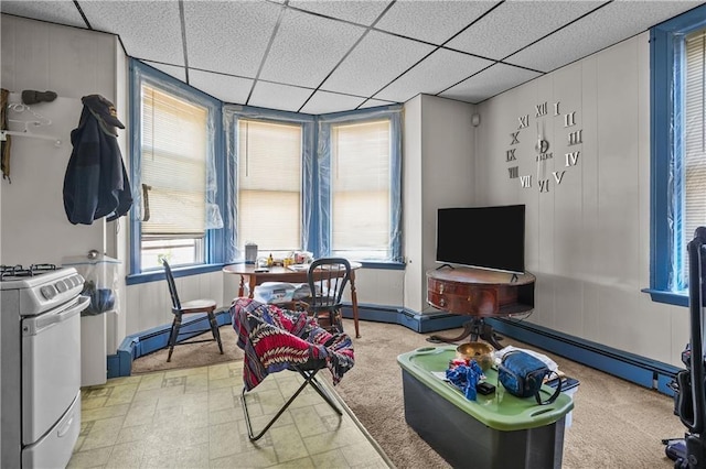 game room with light carpet, baseboard heating, and a paneled ceiling