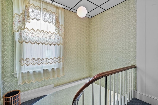 staircase with a paneled ceiling