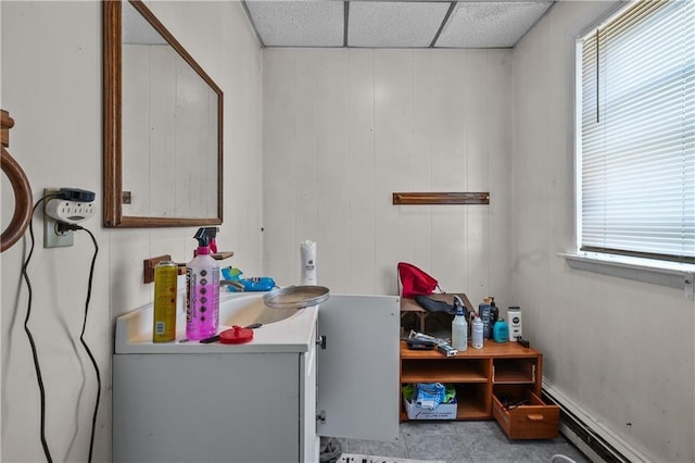 bathroom with a baseboard radiator, a paneled ceiling, and vanity