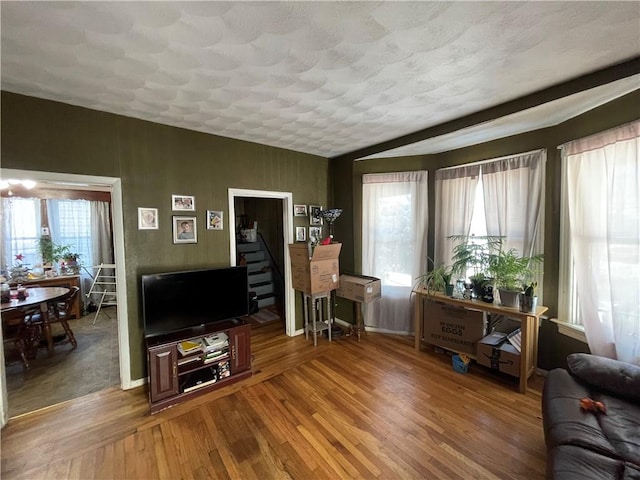 living room with hardwood / wood-style floors and a healthy amount of sunlight