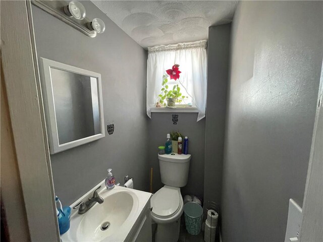 bathroom with toilet and vanity