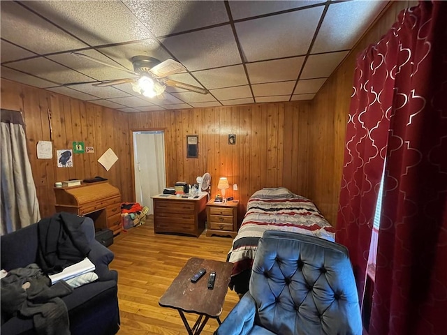 bedroom featuring a paneled ceiling, hardwood / wood-style floors, and ceiling fan