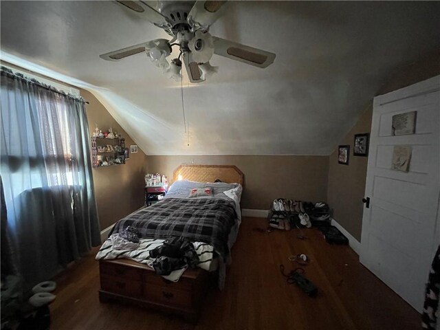 bedroom with dark wood-type flooring, ceiling fan, and lofted ceiling