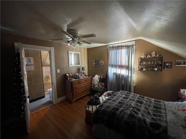 bedroom with ceiling fan, lofted ceiling, and hardwood / wood-style floors