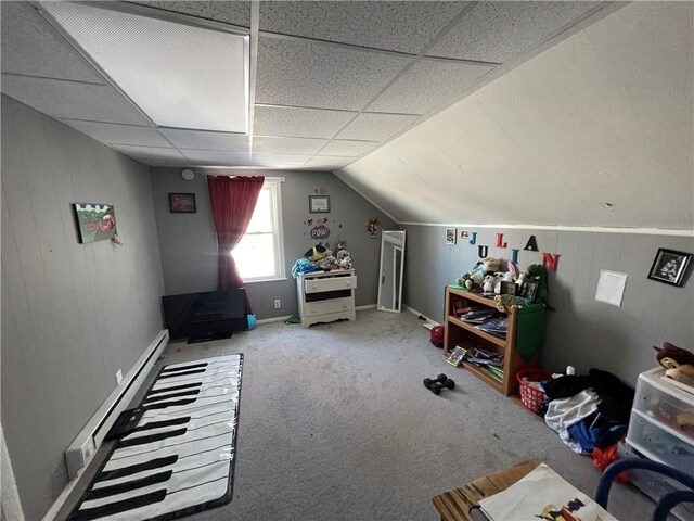 additional living space featuring carpet, a baseboard heating unit, and vaulted ceiling