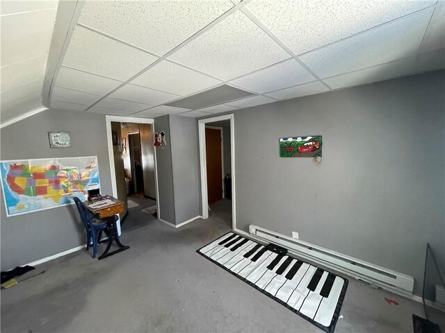 miscellaneous room featuring a paneled ceiling and concrete floors