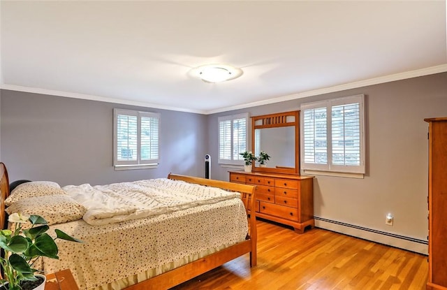 bedroom with baseboard heating, crown molding, and hardwood / wood-style flooring