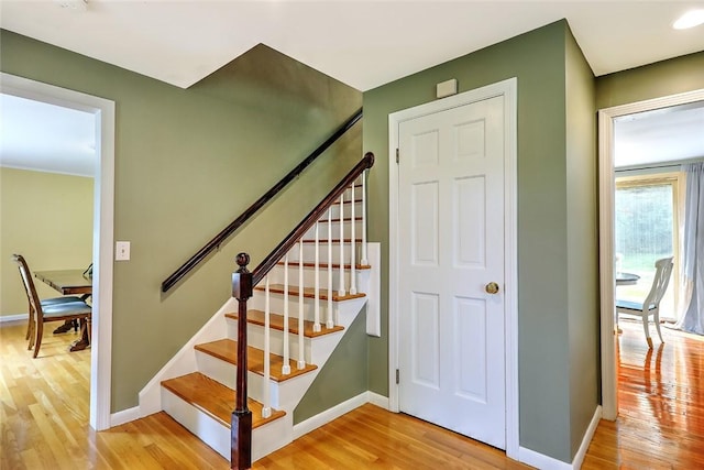 stairs with hardwood / wood-style flooring