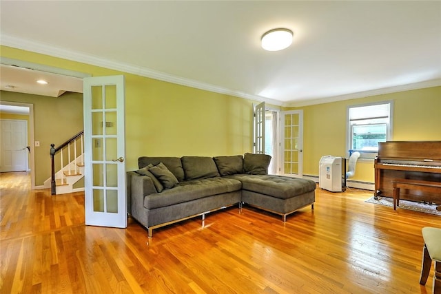 living room featuring ornamental molding, wood-type flooring, and french doors