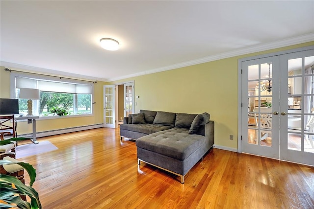 living room featuring baseboard heating, crown molding, french doors, and light wood-type flooring